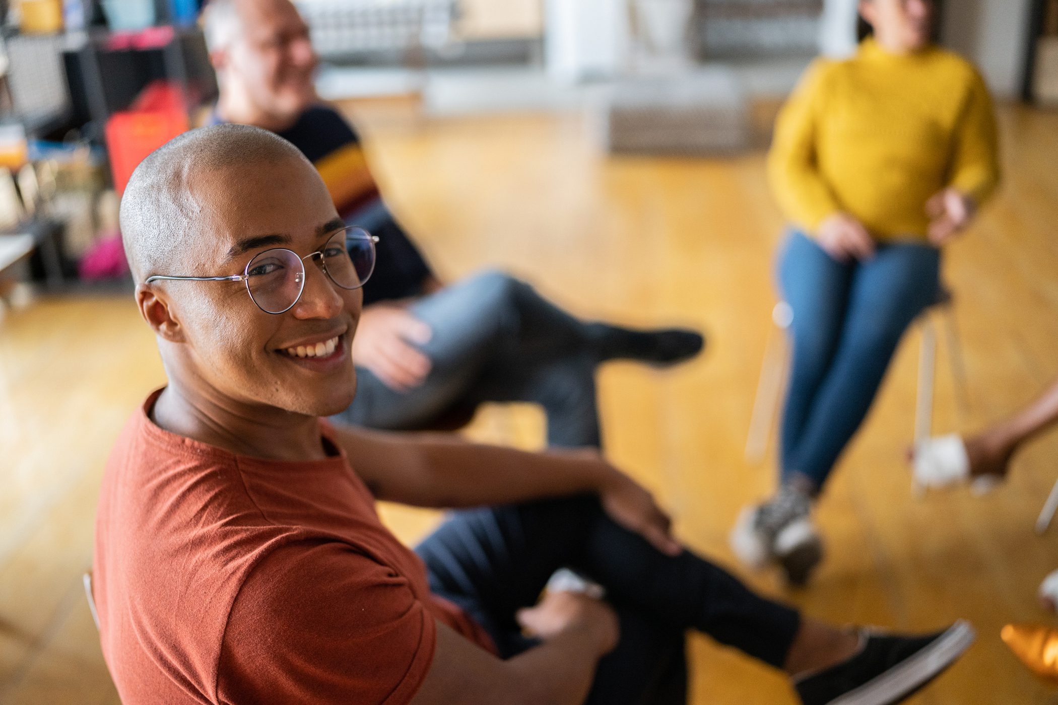 man looks at camera and smiles during therapy session