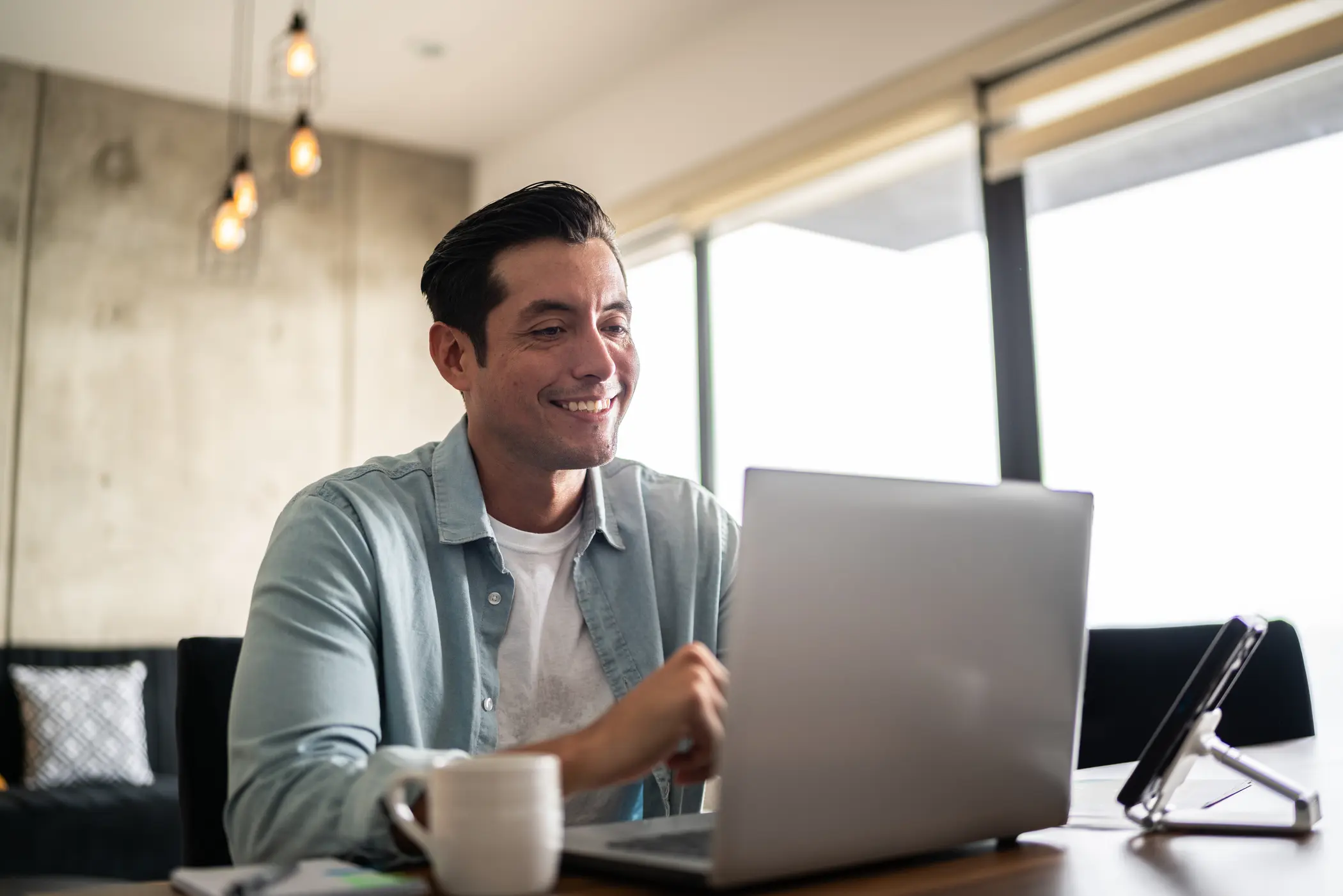 man smiling while talking to someone on a virtual call
